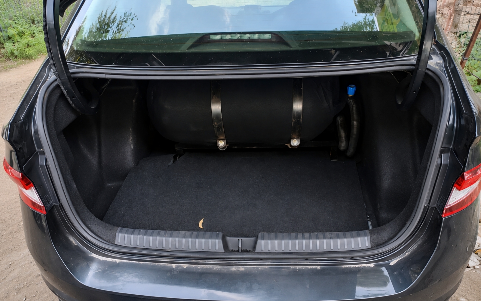 CNG cylinder neatly fitted in car boot with usable space remaining